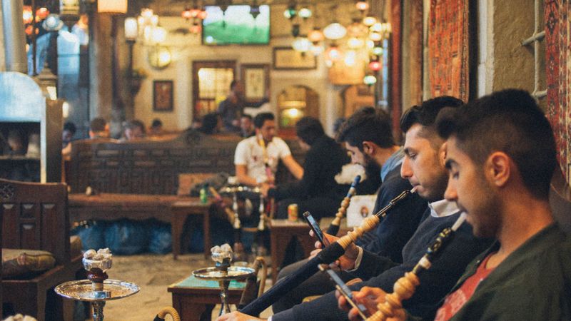 Group of friends smoking hookah in a traditional lounge