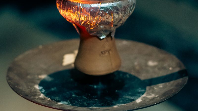 Close-up of hookah bowl with glowing charcoal