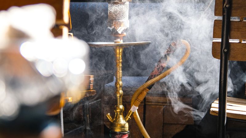 Hookah pipe surrounded by thick smoke clouds